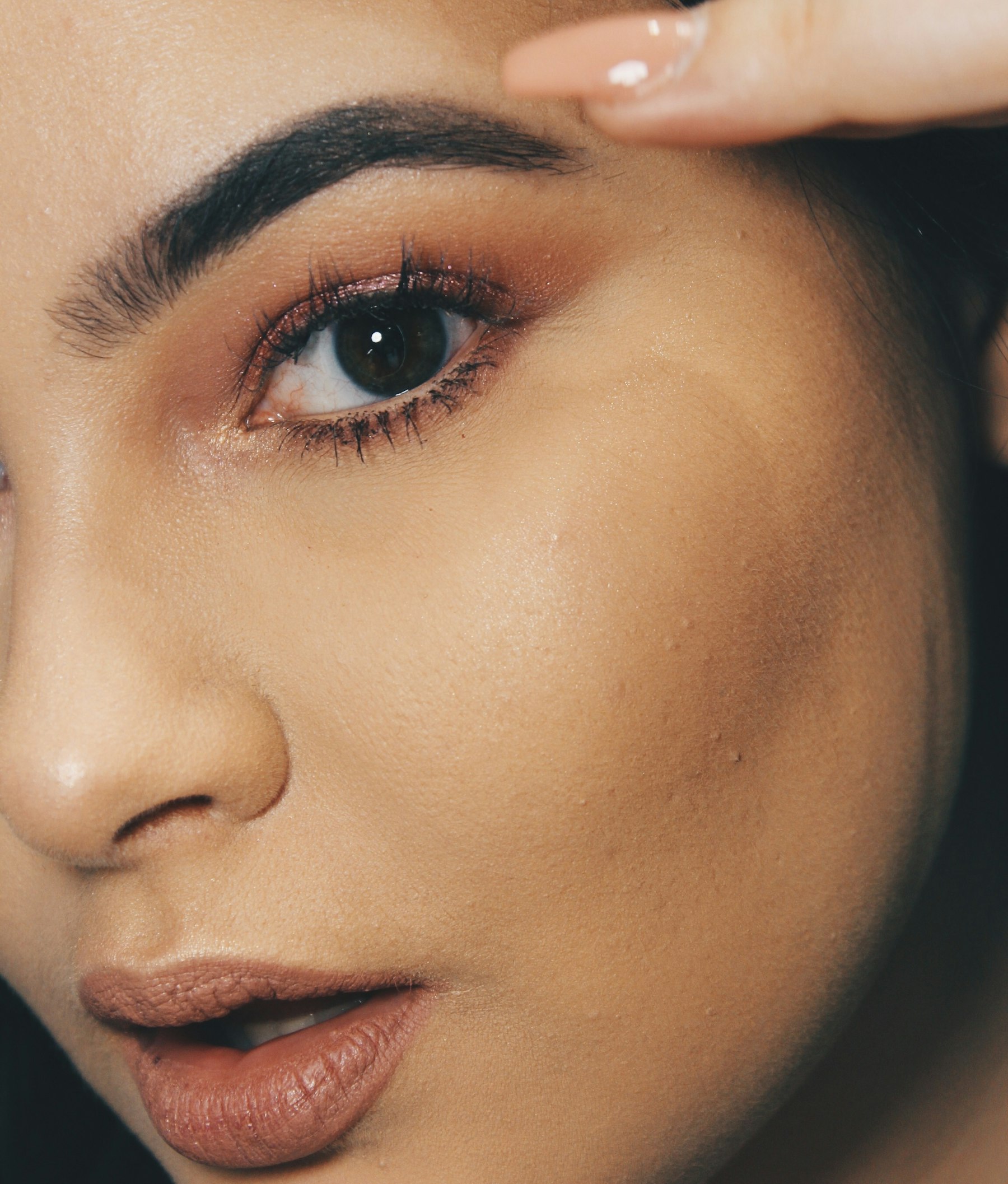 Editorial close-up of a smooth cheek and jawline in soft natural light